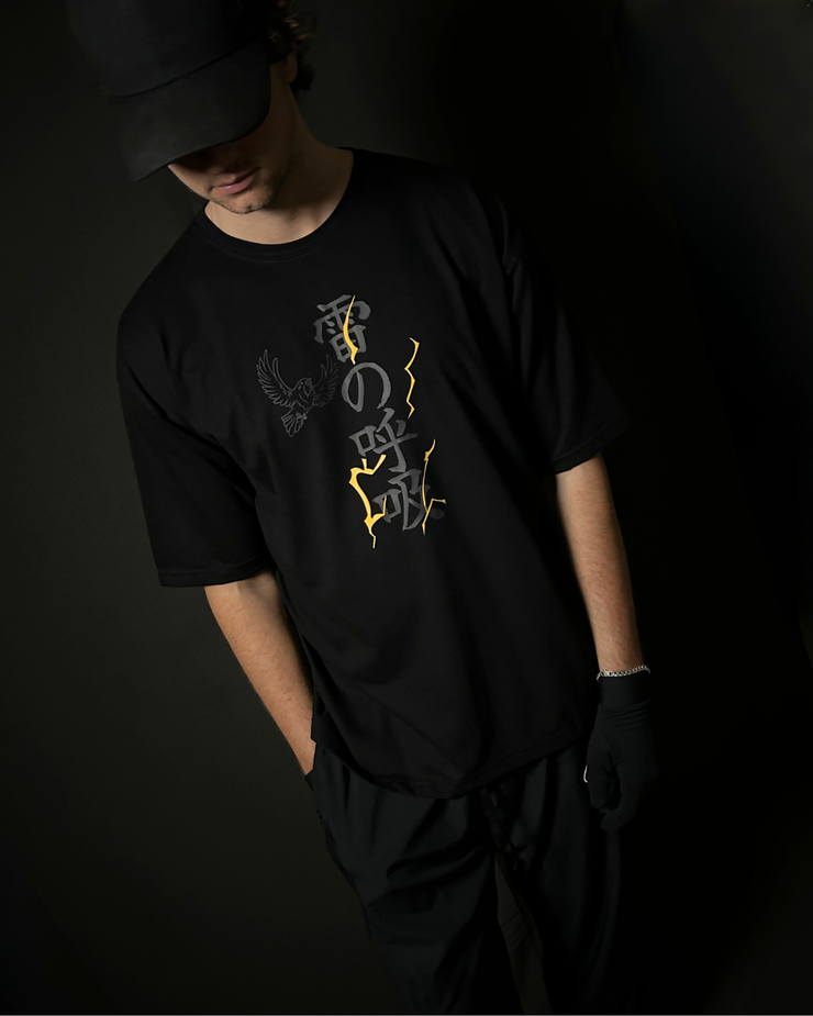 Anime-inspired apparel featuring bold back artwork, worn by a model in a dark studio setting – from a South African anime clothing brand.