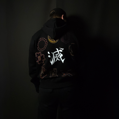 Anime-inspired apparel featuring bold back artwork, worn by a model in a dark studio setting – from a South African anime clothing brand.